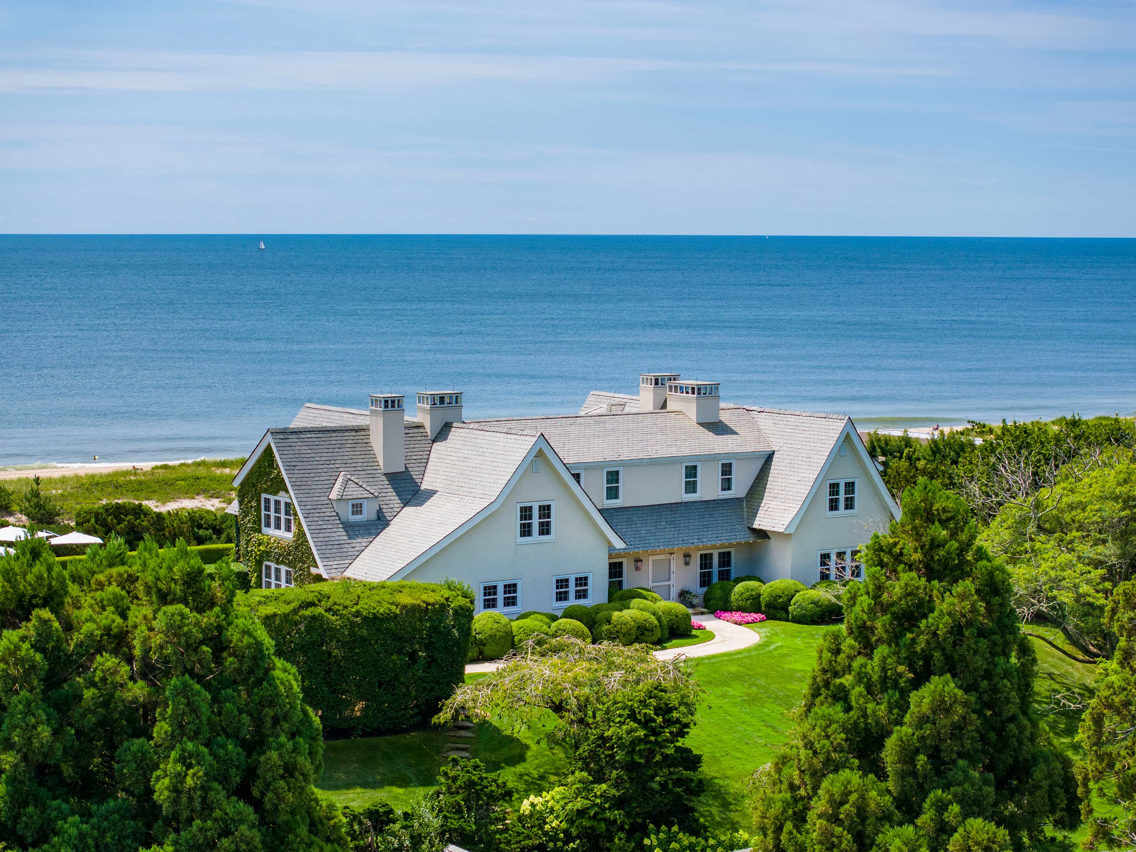43 East Dune Lane, East Hampton, an oceanfront Hedgerow sale, with the Atlantic beyond, in black and white